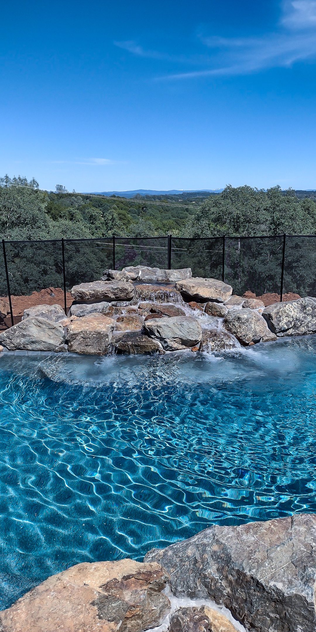 pool with natural rock waterfall